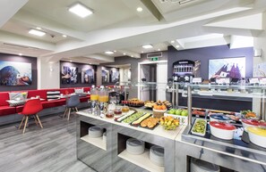 A modern breakfast buffet with a variety of food options, seating areas, and a coffee station. - Leonardo Boutique Hotel Barcelona Sagrada Familia (Barcelona)