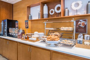 A breakfast buffet with various food items and a coffee station. - SpringHill Suites Huntsville Downtown (Huntsville)