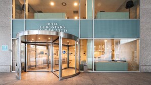 A hotel entrance with a revolving door, glass facade, and a sign reading "HOTEL EUROSTARS". - Eurostars Mar de Vigo (Vigo)