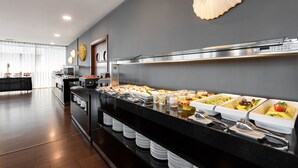 A buffet with various food items and a modern kitchen in the background. - Eurostars Mar de Vigo (Vigo)