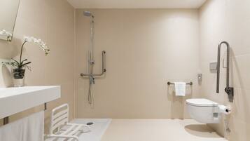 A modern bathroom with a shower, toilet, and a towel rack.