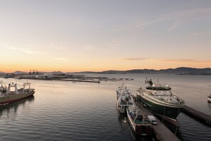 A harbor with ships docked, a pier, and distant hills. - Eurostars Mar de Vigo (Vigo)