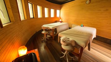 Cozy retreat with a comfortable bed, table, and stool, set against a warm interior.