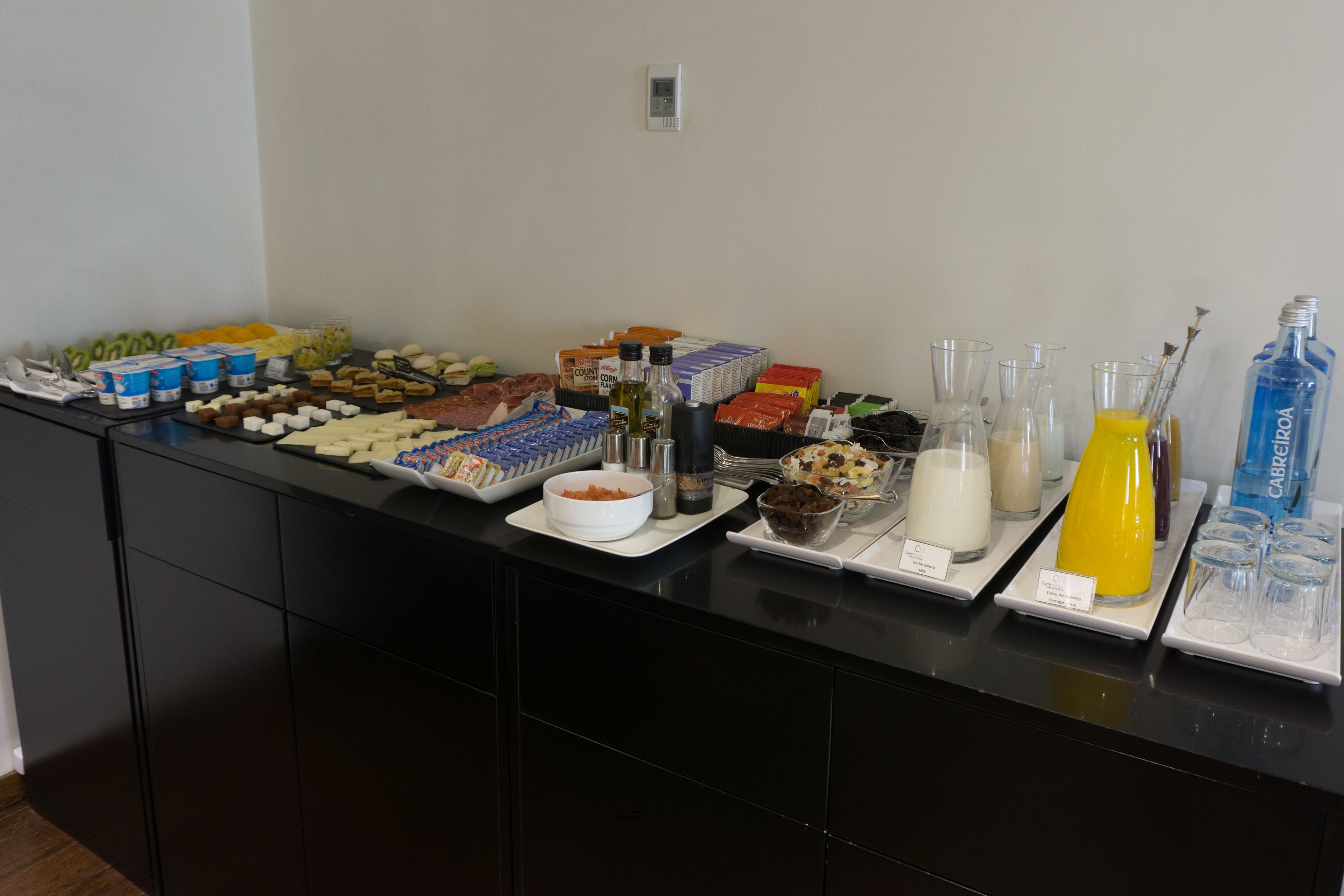 A buffet spread with various food items and beverages.