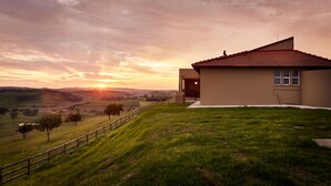 A house with a red-tiled roof, a wooden fence, and a grassy lawn. - First Group Midlands Saddle and Trout (Mooirivier)