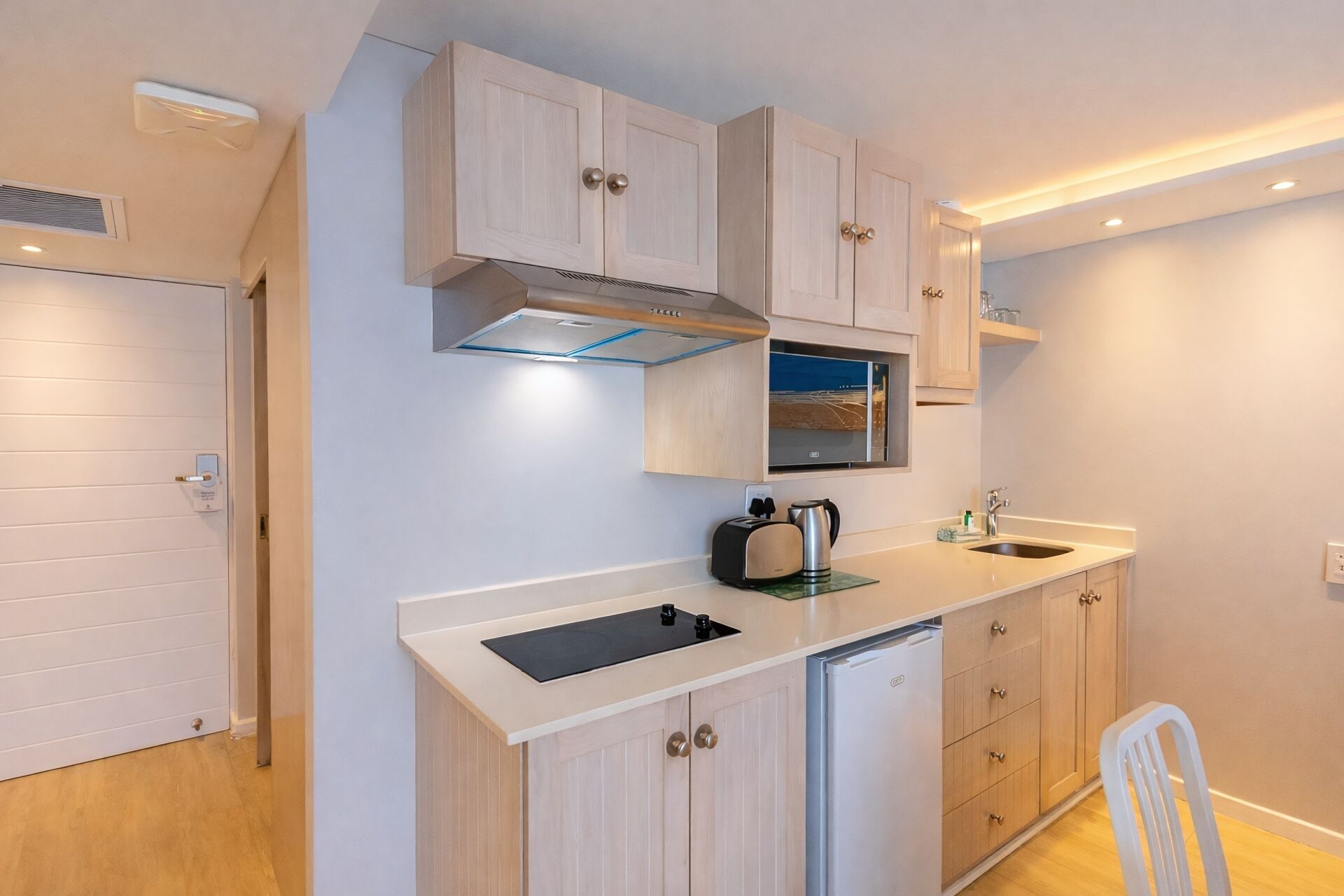 A modern kitchen with a built-in microwave, a stove, and a sink.