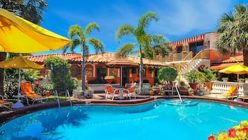 Relax by the pool surrounded by lush gardens and comfortable lounge chairs.