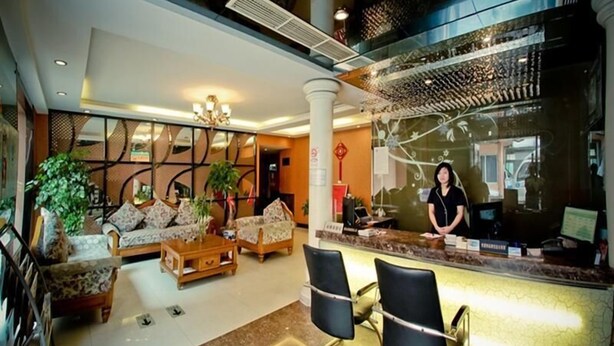 A hotel lobby with a reception desk, seating area, and decorative elements. - GreenTree Inn WenZhou XiaoNanMen Express Hotel (Wenzhou)