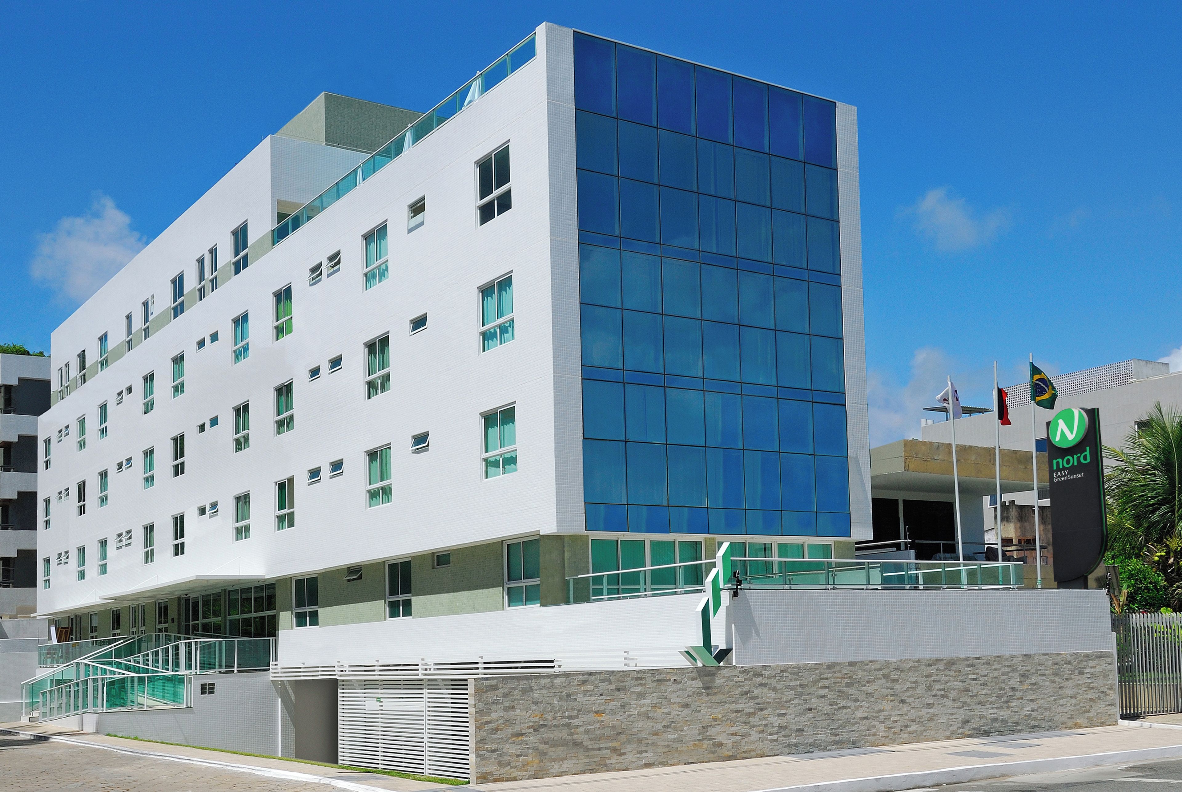 A modern building with a white facade and large glass windows.