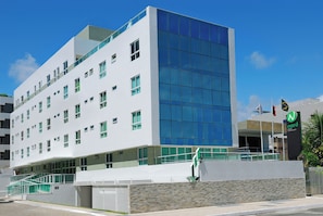 A modern building with a white facade and large glass windows.