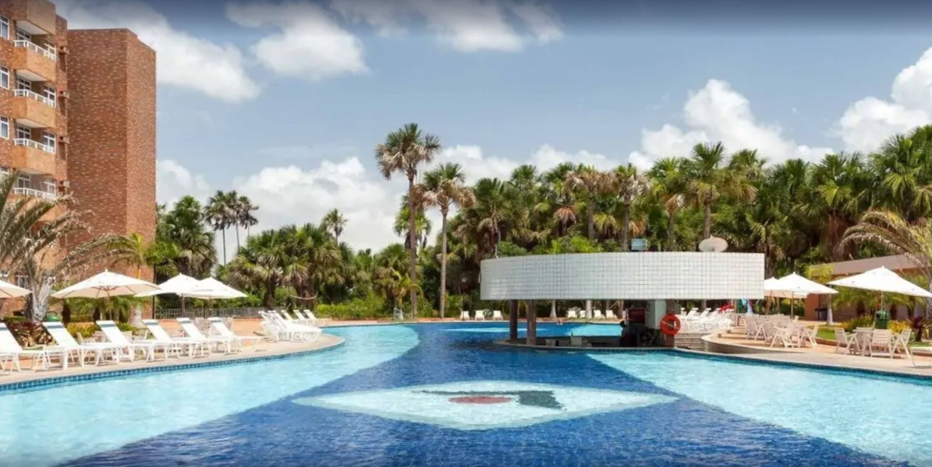 Una piscina al aire libre, sillones reclinables de piscina