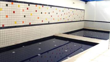 Relax by the rectangular pool surrounded by colorful tile walls.
