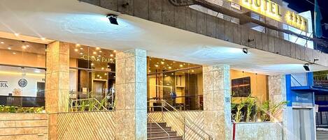 The exterior of the Cesar Park Hotel with a prominent entrance, a staircase leading to the lobby, and a clear view of the hotel's name.
