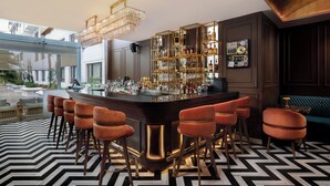 A bar area with a modern design, featuring a bar counter, multiple stools, and a chandelier. - Hotel Himalaya Kathmandu - Your Business & Leisure Retreat (Lalitpur)