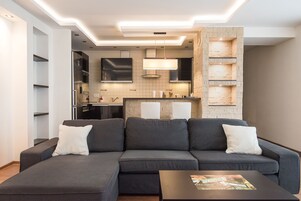 Deluxe Apartment, 2 Bedrooms | Living room | 32-inch TV with cable channels