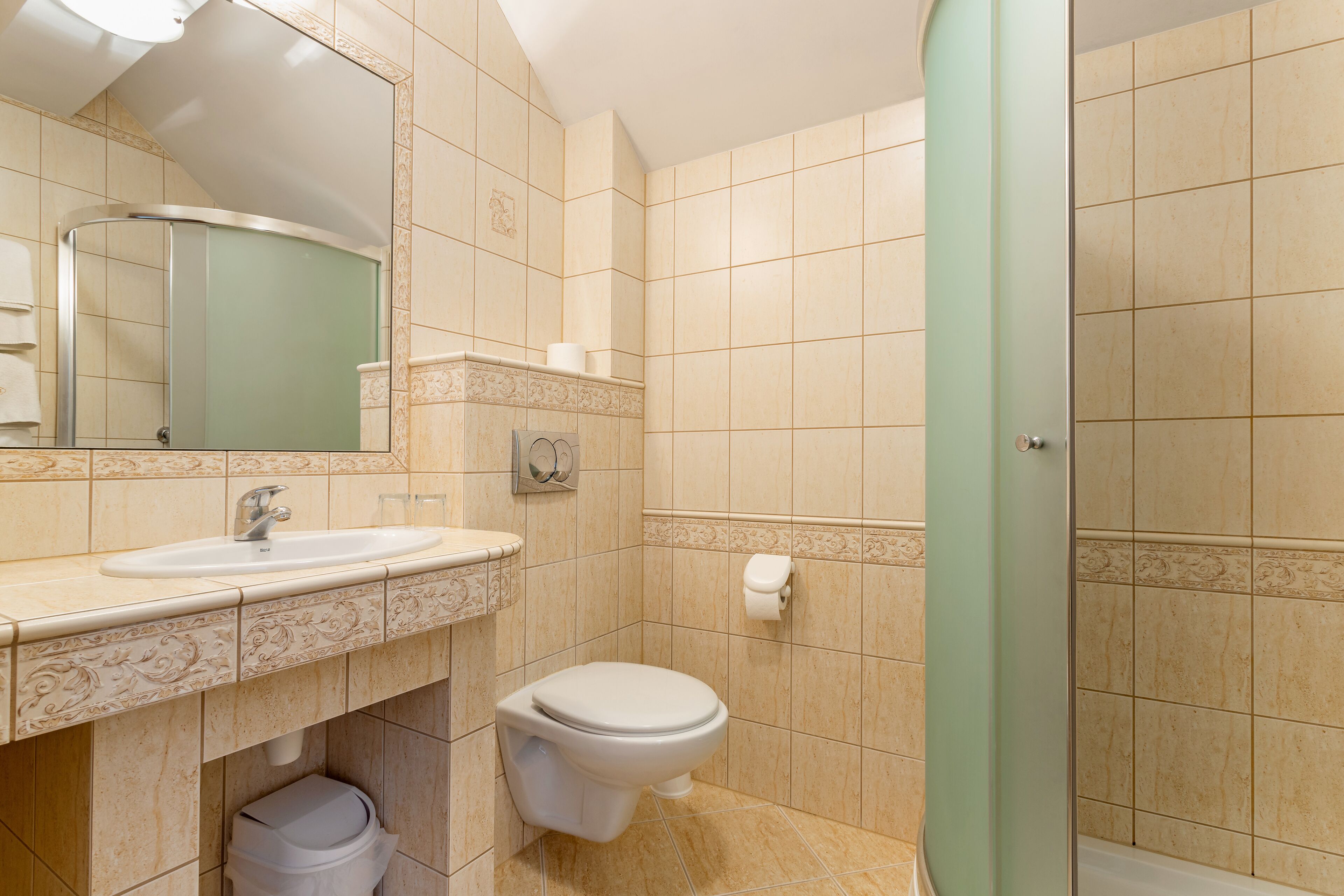 A bathroom with a sink, toilet, and shower.