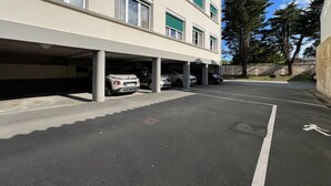 A multi-story parking garage with several cars parked under the structure.