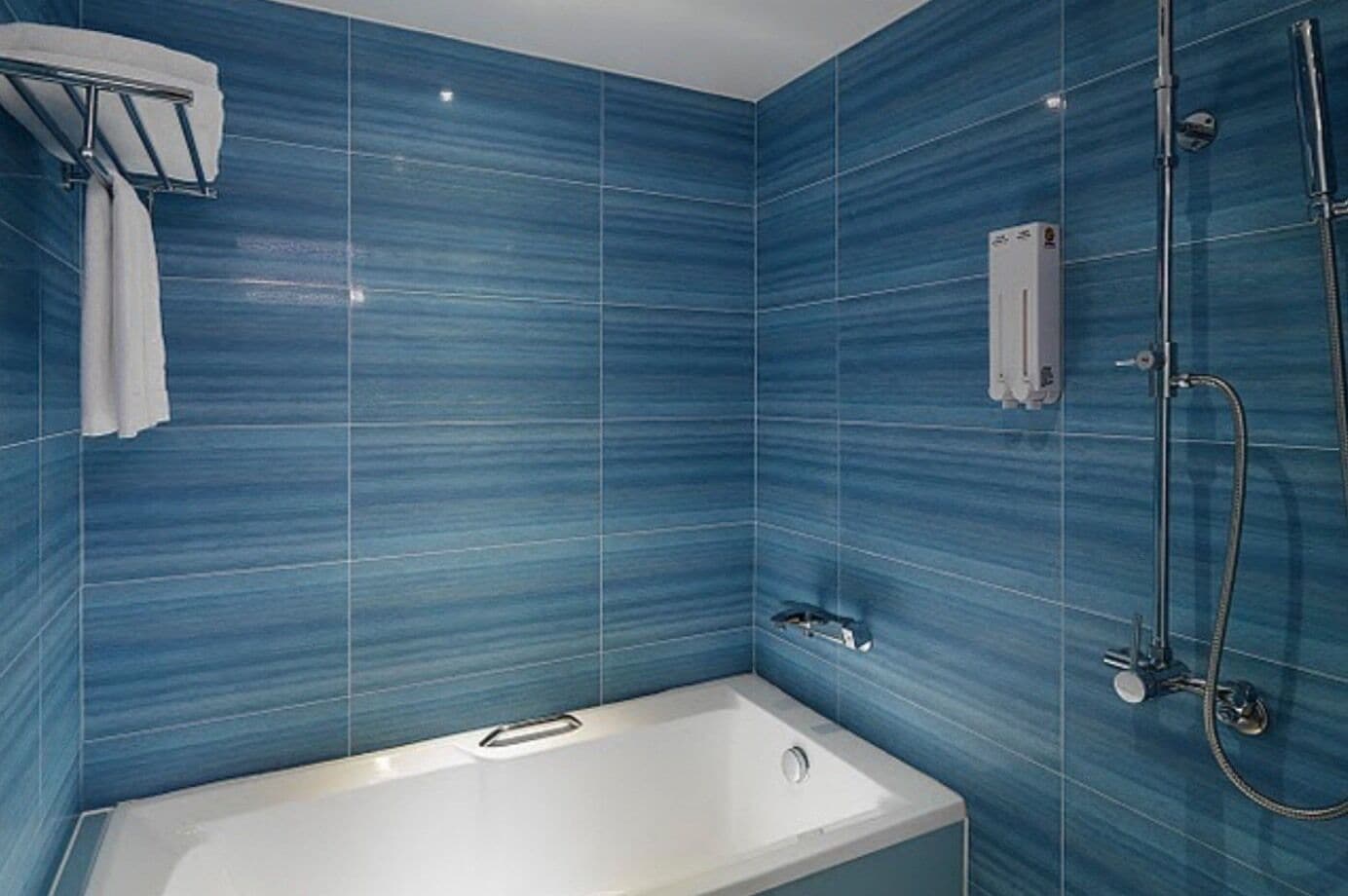 deluxe family room  | bathroom | shower, rainfall showerhead, free toiletries, hair dryer