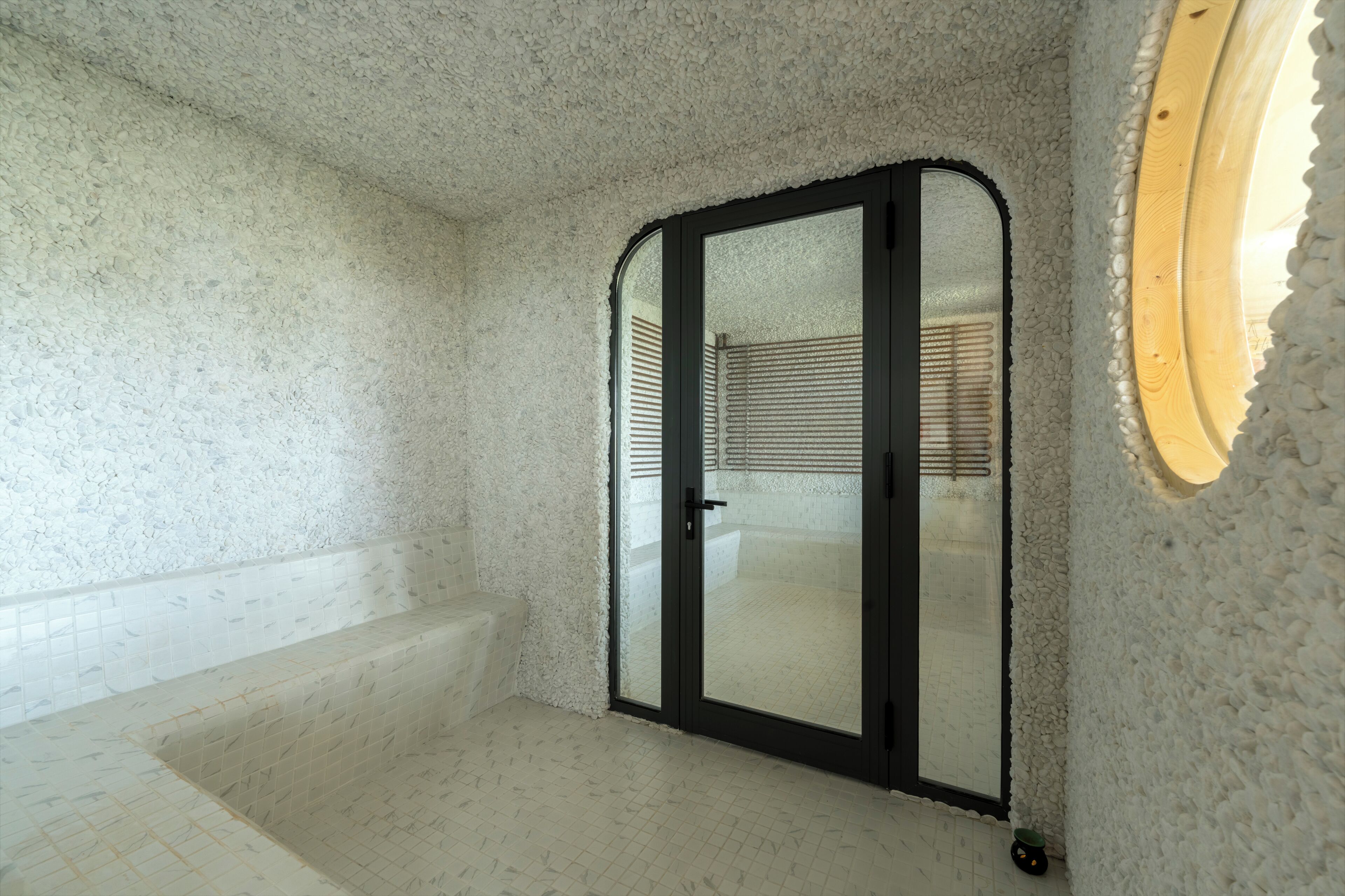 A bathroom with a bathtub, a shower area, and a glass door.