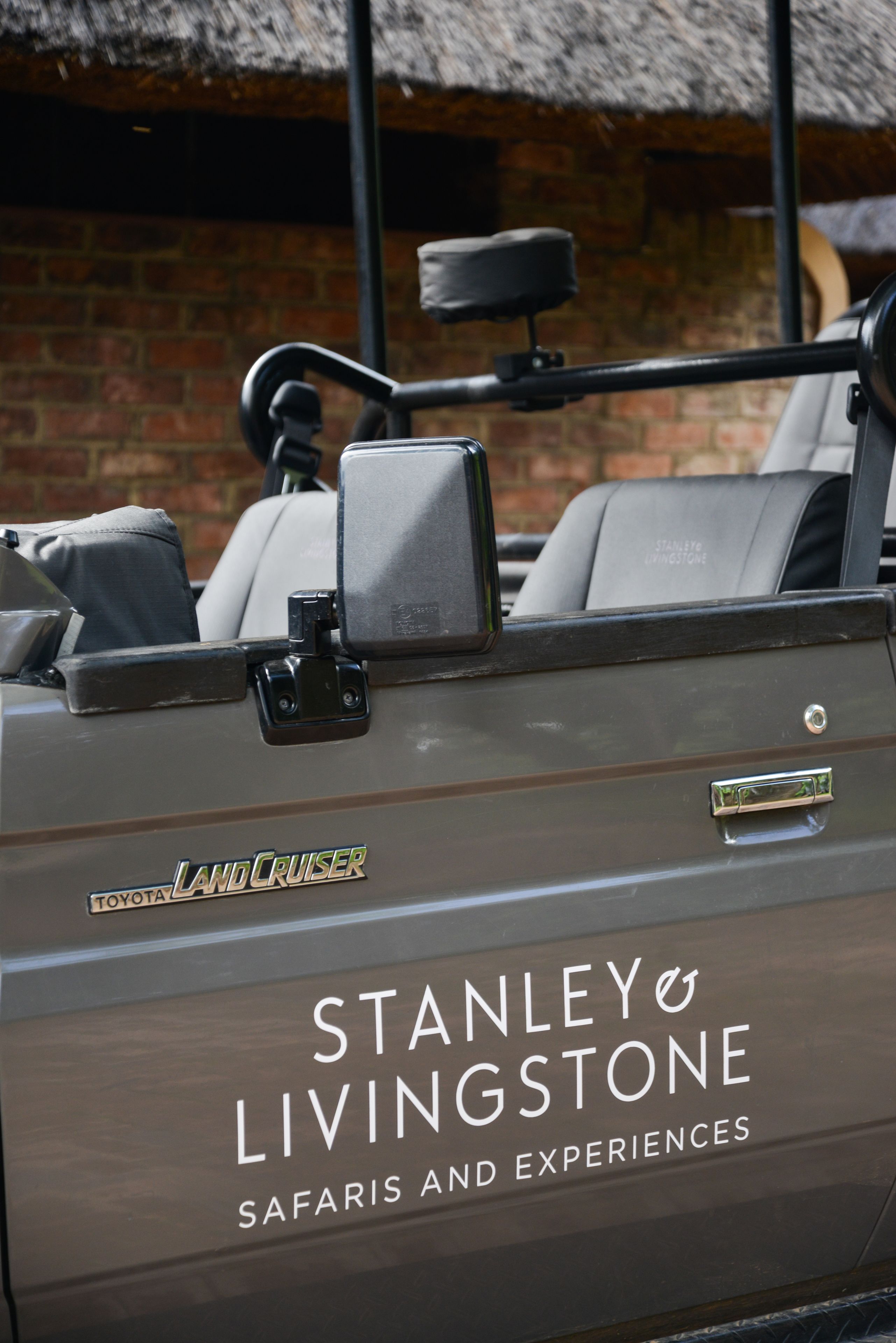 A vehicle with "LAND CRUISER" and "STANLEY LIVINGSTONE SAFARIS AND EXPERIENCES" branding.