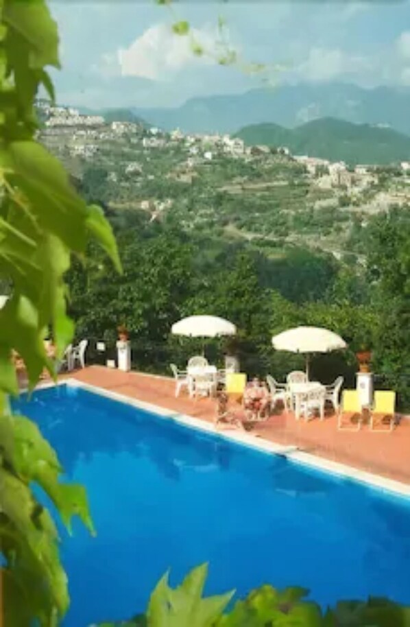 Seasonal outdoor pool, open 9:00 AM to 5:30 PM, pool umbrellas