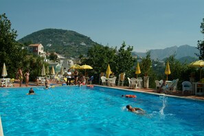 Seasonal outdoor pool, open 9:00 AM to 5:30 PM, pool umbrellas