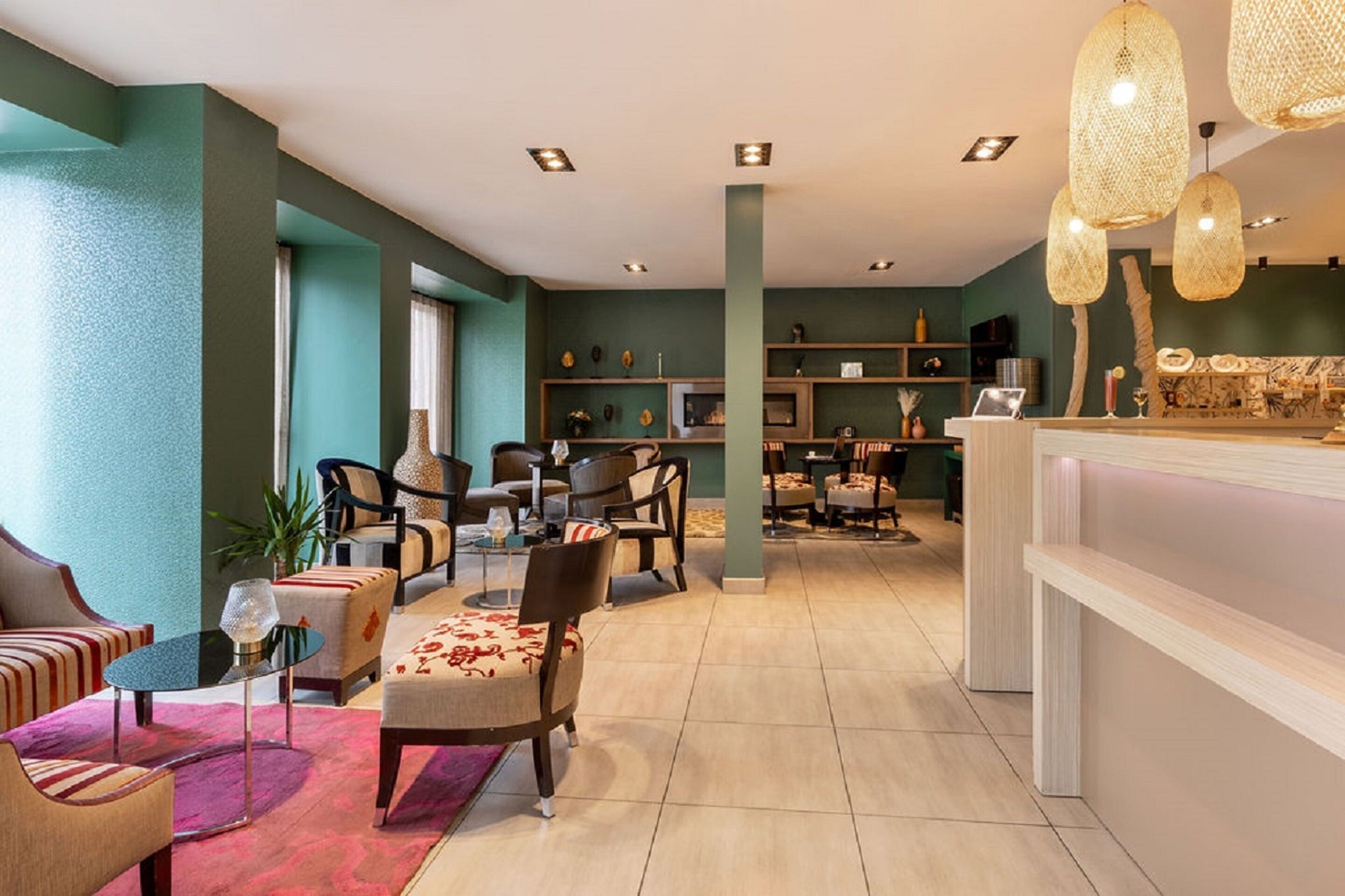 Een moderne hotellobby met een eetgedeelte, zitplaatsen en een receptiebalie.