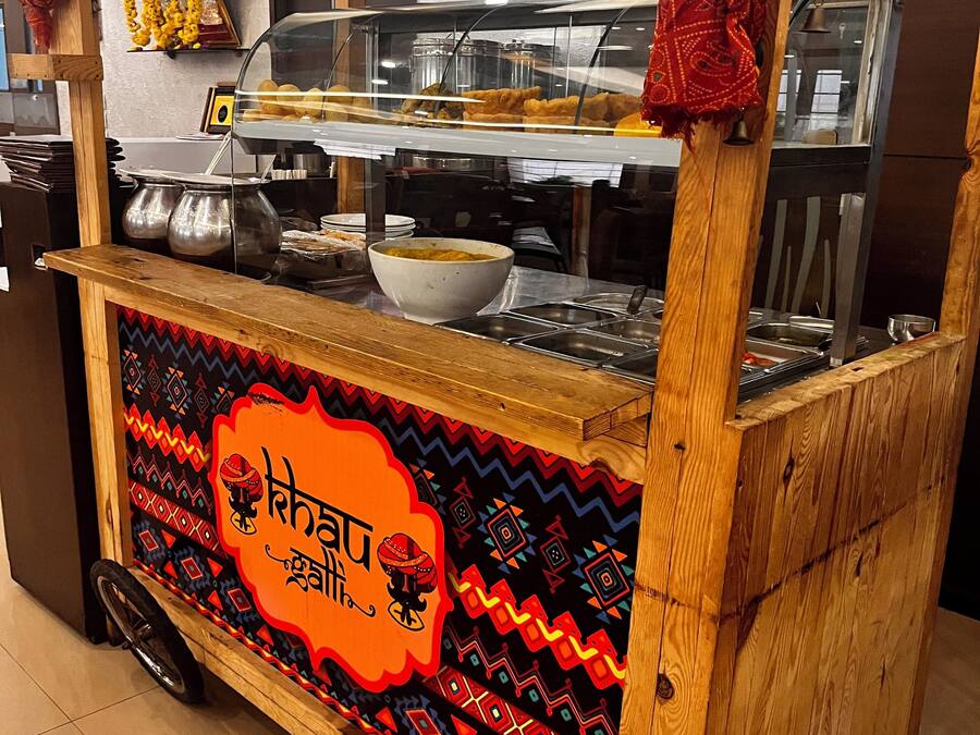 A food cart with a colorful design and a bowl of food.