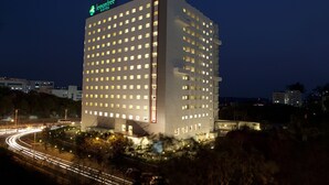 A multi-story hotel with illuminated windows and signage for 'lemontree' and 'Fefox Hotel'. - Red Fox by Lemon Tree Hotels, Hyderabad (Hyderabad)