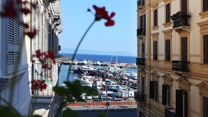A marina with boats docked, surrounded by buildings with balconies. - H Rooms Boutique Hotel (Naples)