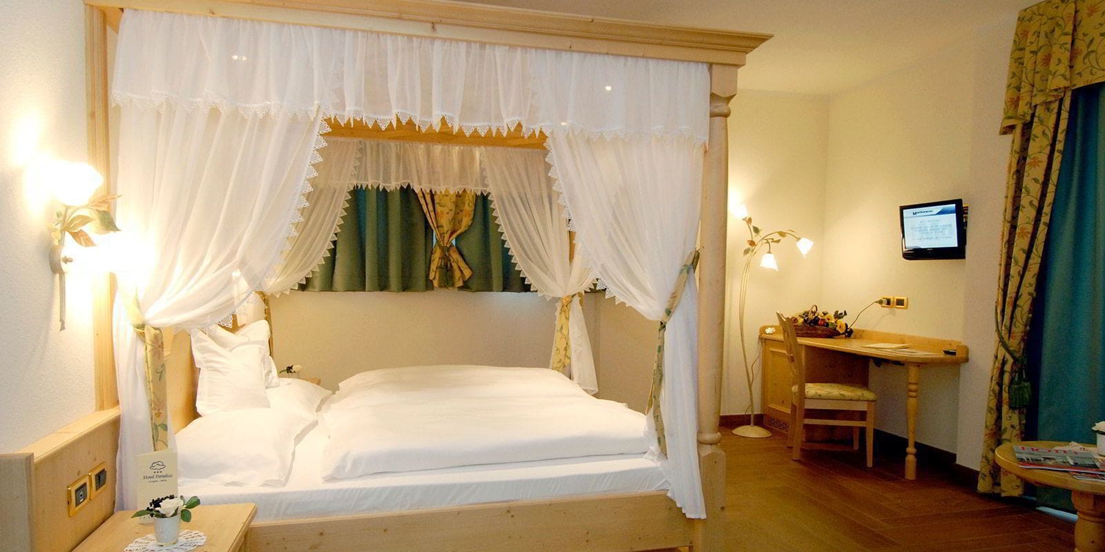 A room with a bed, a desk, and a chair.