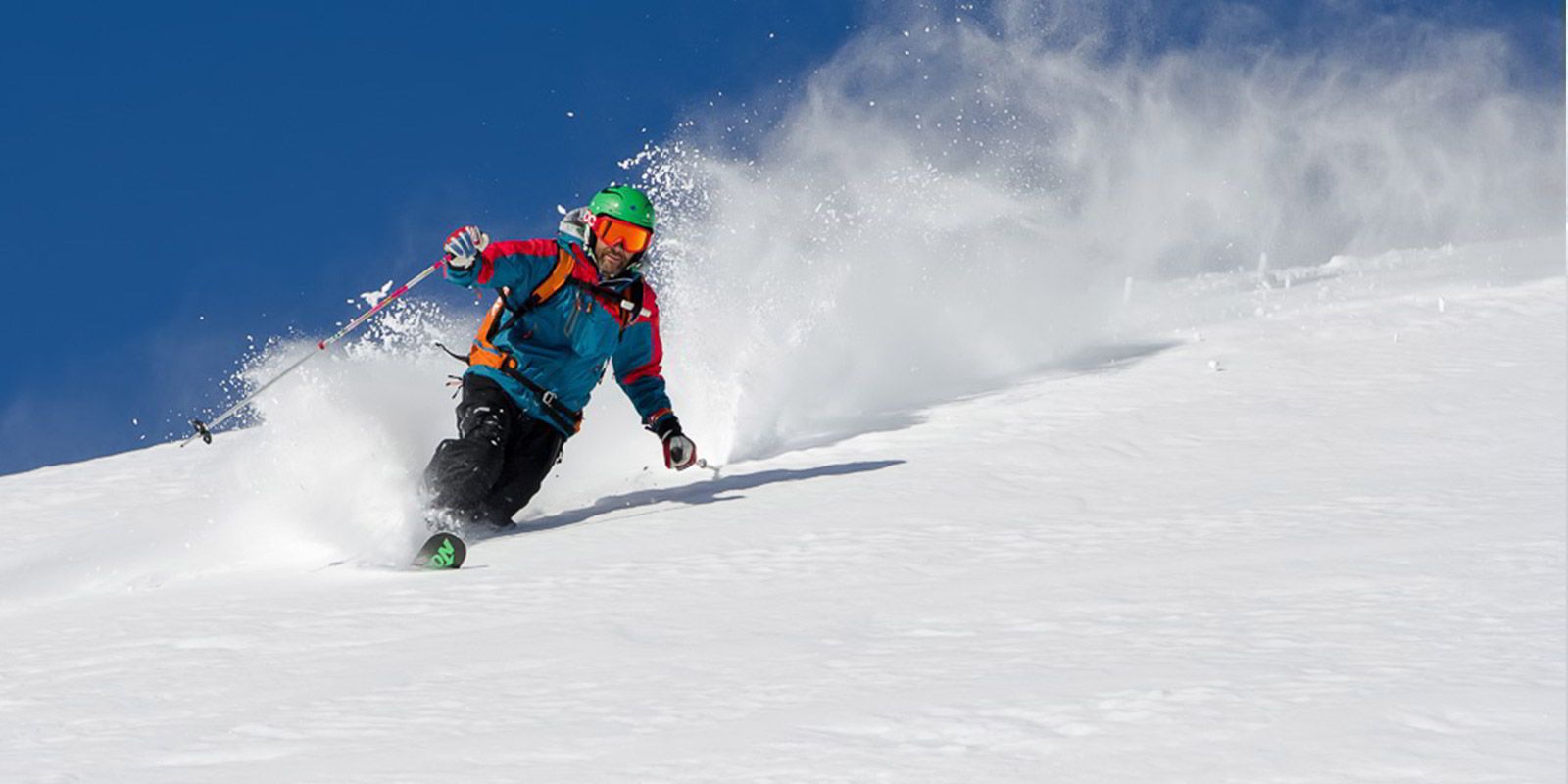 A person skiing down a snowy slope.