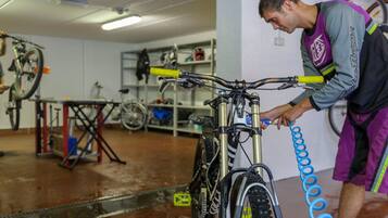 A bicycle repair station with a person working on a bike.