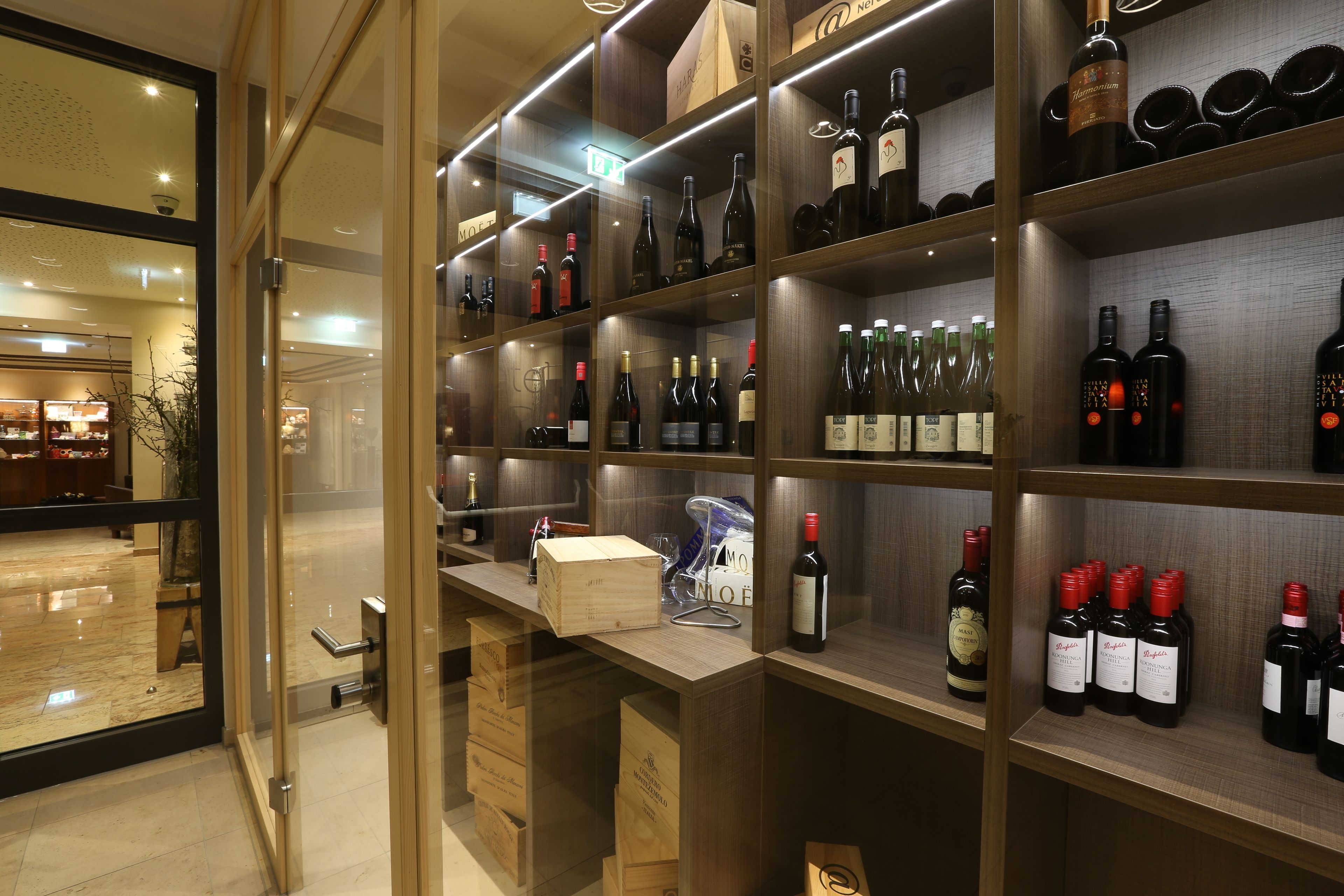 A wine cellar with shelves stocked with various bottles and boxes.