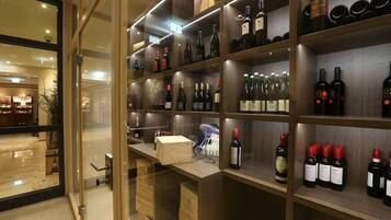 A wine cellar with shelves stocked with various bottles and boxes.