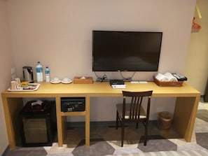 Work in comfort with a desk, flat-screen TV, and convenient amenities.