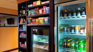 A self-service beverage and snack vending area with a variety of products including chips, snacks, and bottled beverages. - Fairfield Inn & Suites by Marriott Charleston Airport/Convention Center (North Charleston)