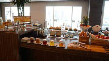 A breakfast buffet with various food items and condiments.