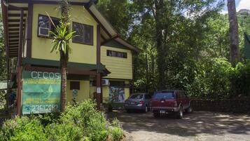 A building with a signboard advertising a community library and conservation efforts.