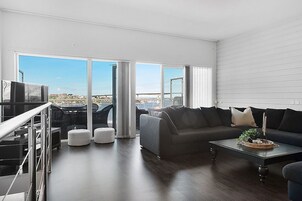 Exclusive Condo, 2 Bedrooms | Living room | Flat-screen TV