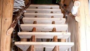 A wooden spiral staircase with a rustic design, made of natural wood and metal accents. - Artharmony Pension & Hostel (Prague)