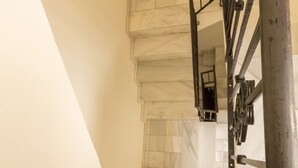 A staircase with a metal railing leading to a higher floor. - White Nest (Granada)