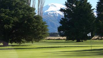 Enjoy a serene golf experience with a stunning mountain backdrop.