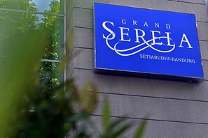 Ein blaues Schild mit der Aufschrift 'Grand Serla' und 'Setiabudhi-Bandung'.