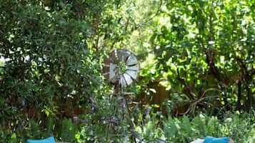 An outdoor seating area with wicker furniture and a windmill.