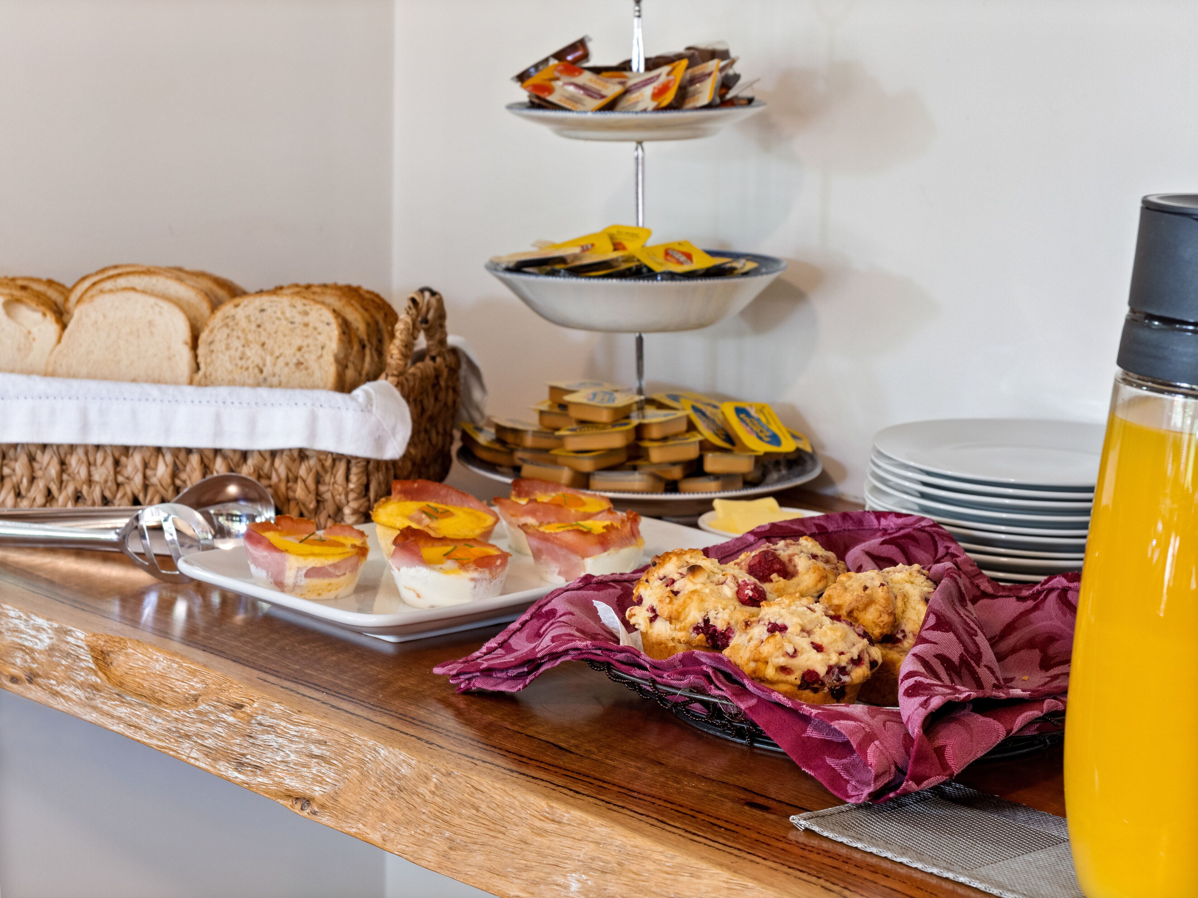 A breakfast buffet with various pastries, bread, and a water bottle.