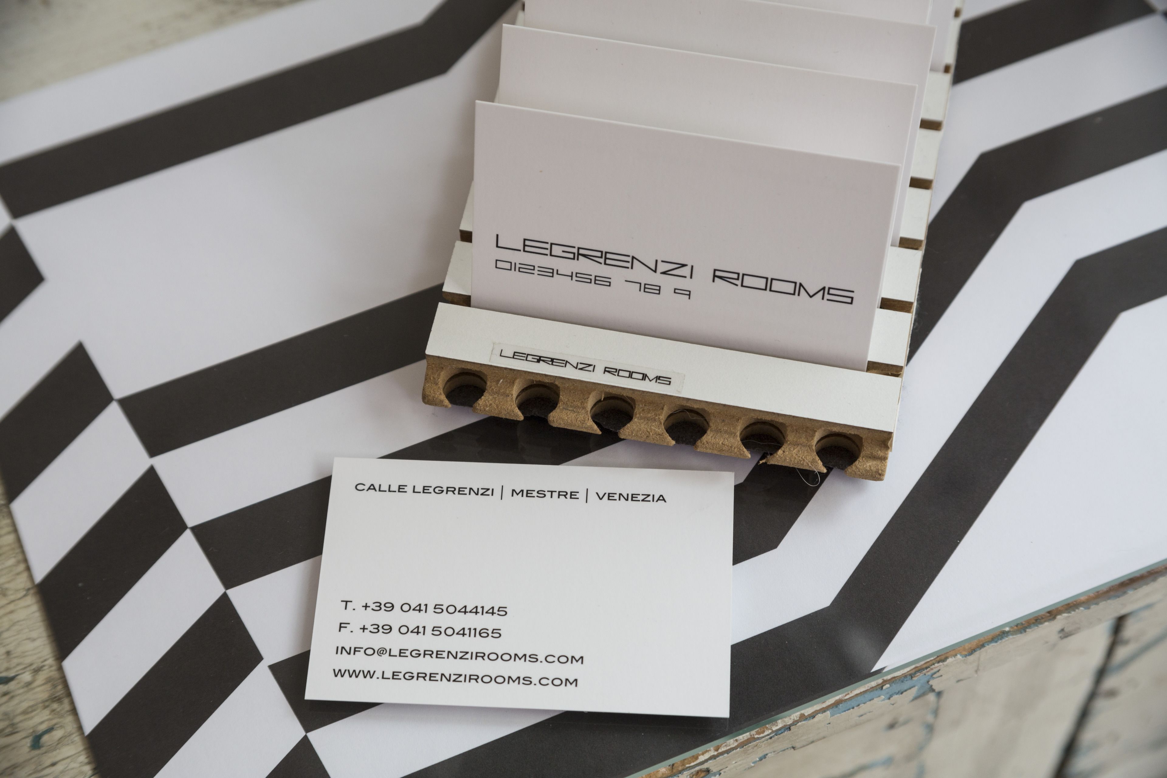 A business card and a brochure for Legrenzi Rooms, including contact information and website URL.