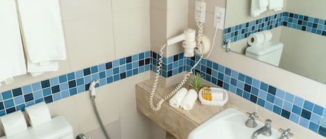 A bathroom with a shower, a sink, and a mirror.