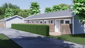 A modern building with a grey roof, white walls, and a green hedge. - First Camp Malmö (Malmö)
