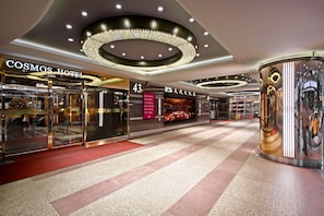A hotel interior with a modern design, featuring a prominent chandelier, a digital display, and a clean, polished floor. - Cosmos Hotel Taipei (Taipei)